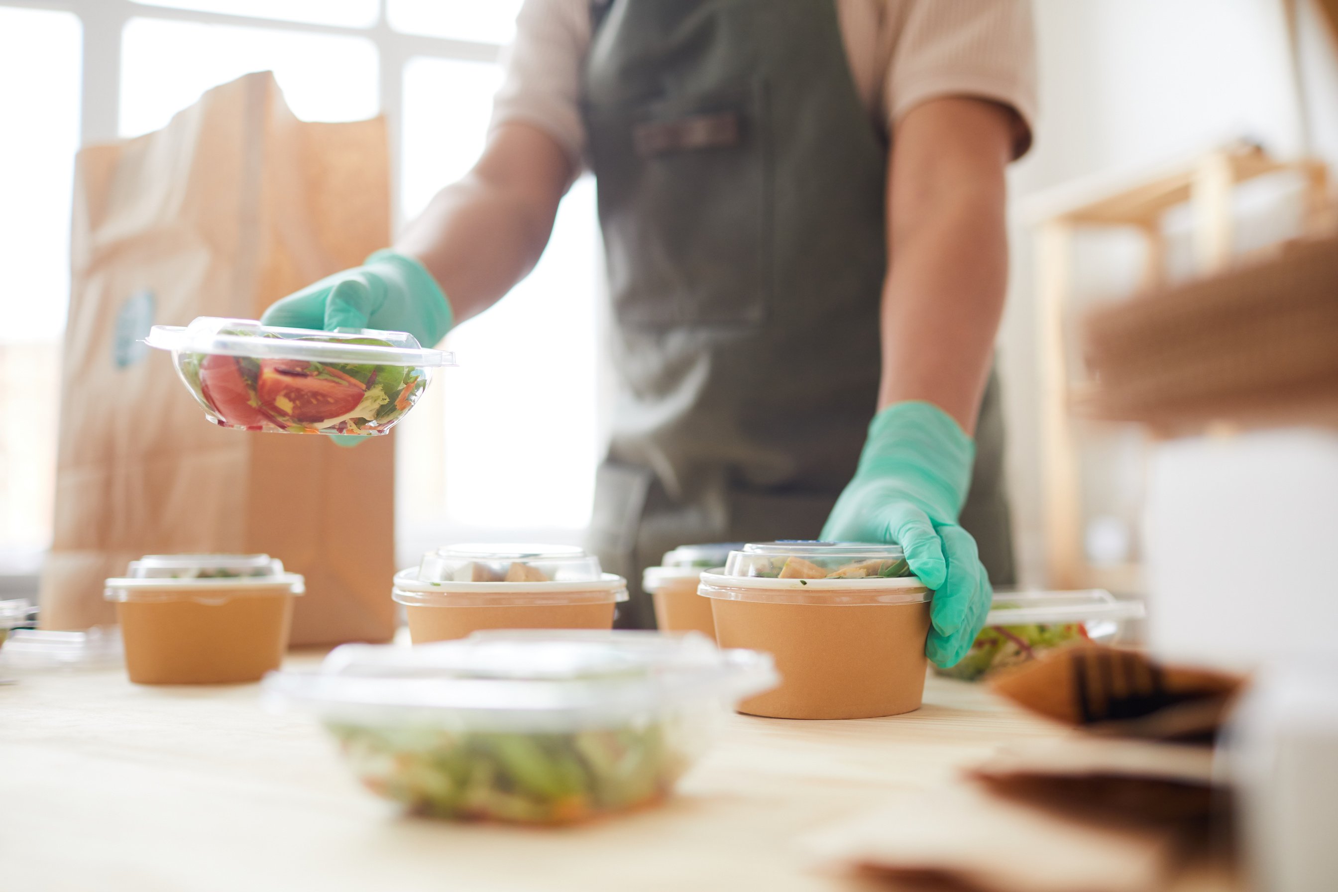 Worker Preparing Takeout Order for Food Delivery Service